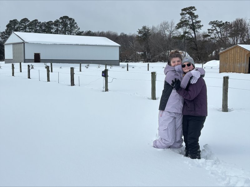 Kayla Hendershot and Mackenzie Mears are delighted with the snow. Photo by Kevin Hendershot at Amazing Grace Acres.