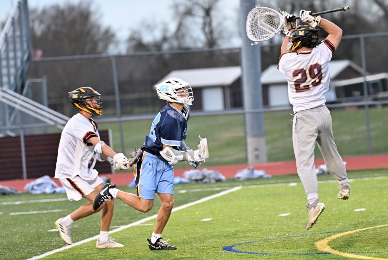 Milford goalie Landen Hill gets major air to make a save on Cape’s Grant Conway.