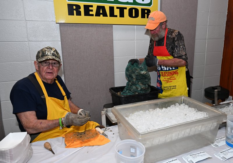 Jim Yingling, left, and his son Jimmy prepare oysters at the raw bar.