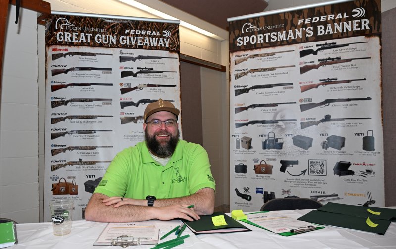Craig Lester works the Wall of Guns booth.