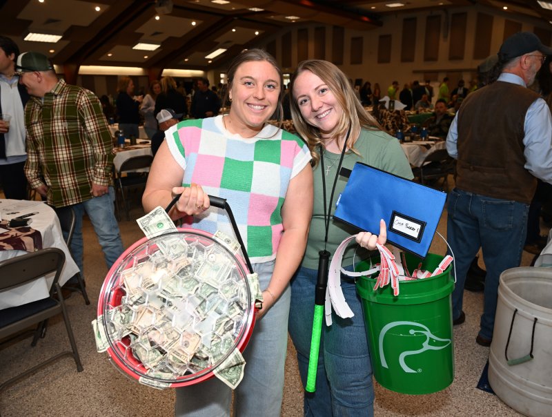 Lynsy Oronzio, left, and Ally Raiche work the raffle for the bucket of cash.
