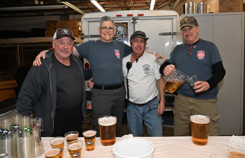 Working the beer booth are (l-r) Mark Lindell, Julie DelGiorno, Kevin Monigle and Marty Schertzer.