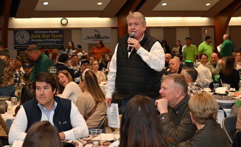 Auctioneer Stephen Harrell works the event.