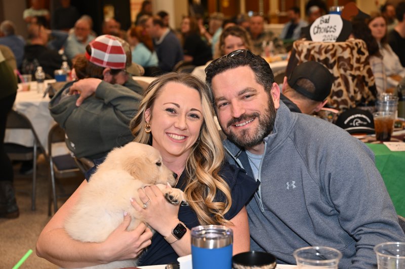 Getting the winning bid on the first puppy are Delsea and Chris Diaferio.