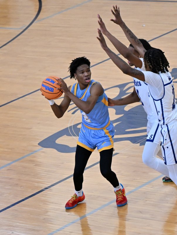 Cape junior Geordan Downing pulls the Howard defense to him and passes underneath for an assist.