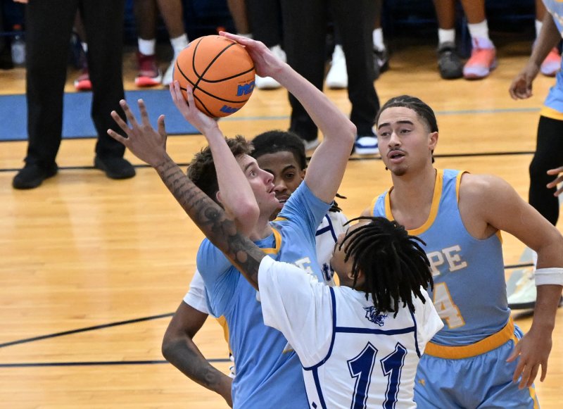 Cape senor Braxton Figgs grabs a rebound over Howard’s Ghazi Abdurrafi. DAN COOK PHOTOS