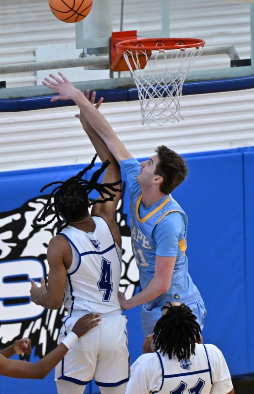 Cape senior Braxton Figgs gets a block on Howard’s Bryson Lane.