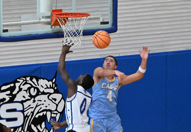 Cape junior Jameson Tingle blocks the shot of Howard’s Nicholas Baysah.