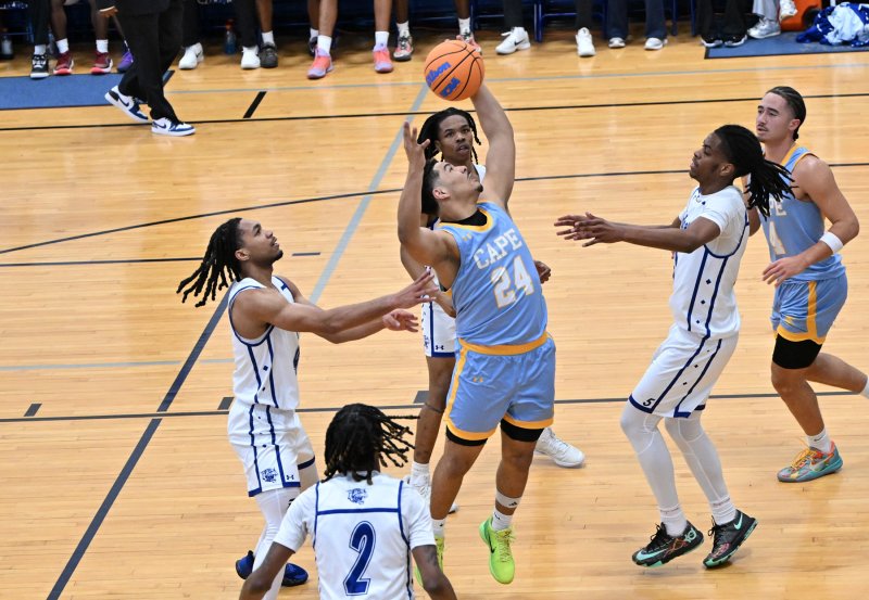 Cape senior Dell Richards controls a rebound over a colony of Wildcats in the paint.