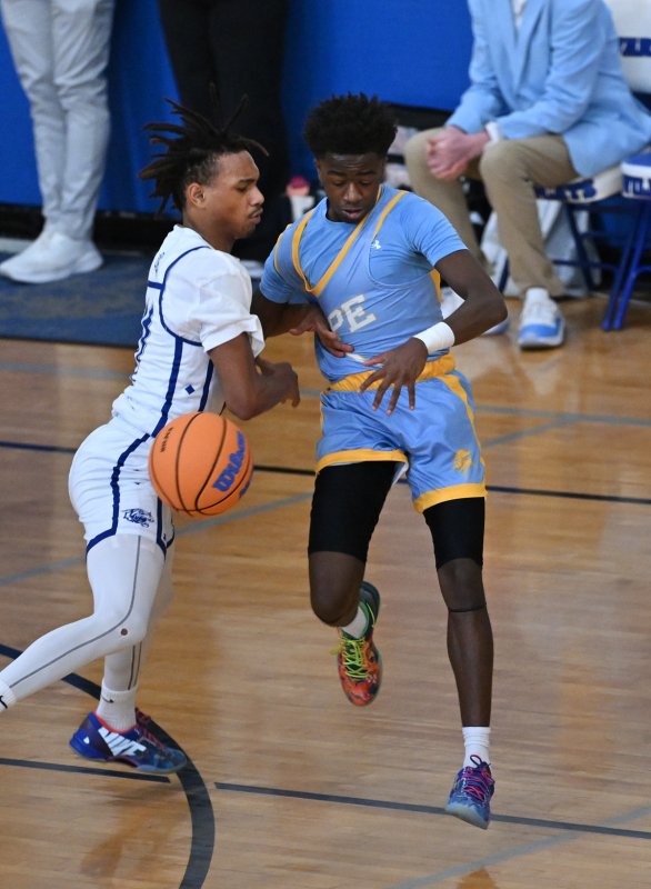 Cape’s Stephen Sivels is fouled by Howard’s Ghazi Abdurrafi.