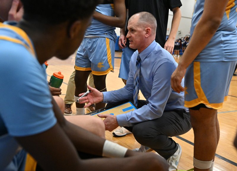 Caper coach Steve Re reviews a play during a third-quarter time out.