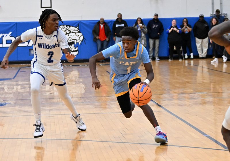 Stephen Sivels drives on Howard’s Ronald Handy.