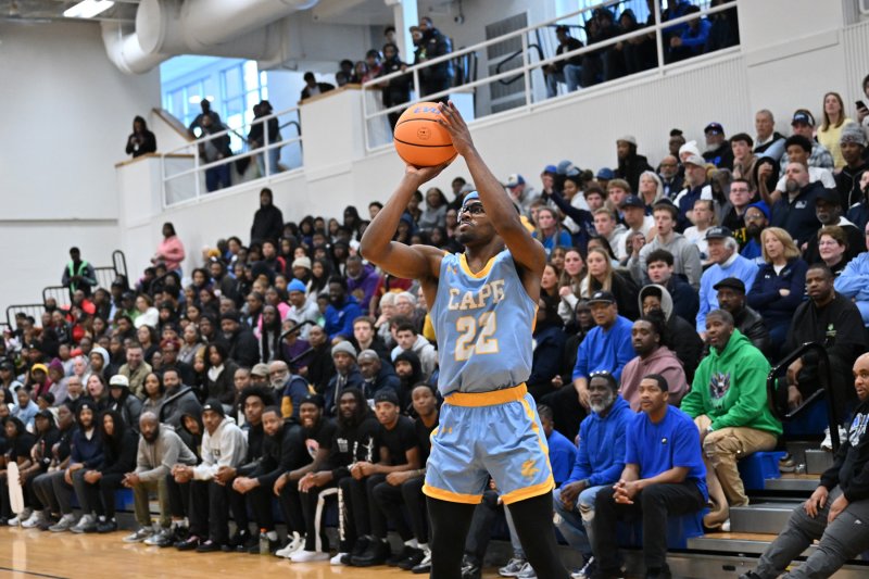 Oz Batson hits from the side.