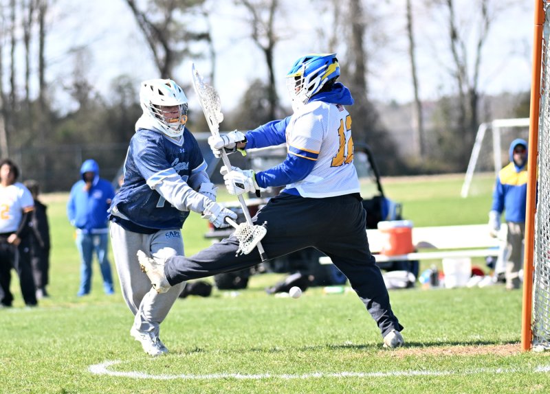 Cape senior Braddock Smith stuffs a shot behind Central goalie Shane McCray in the 22-0 shutout of the Golden Knights. DAN COOK PHOTOS