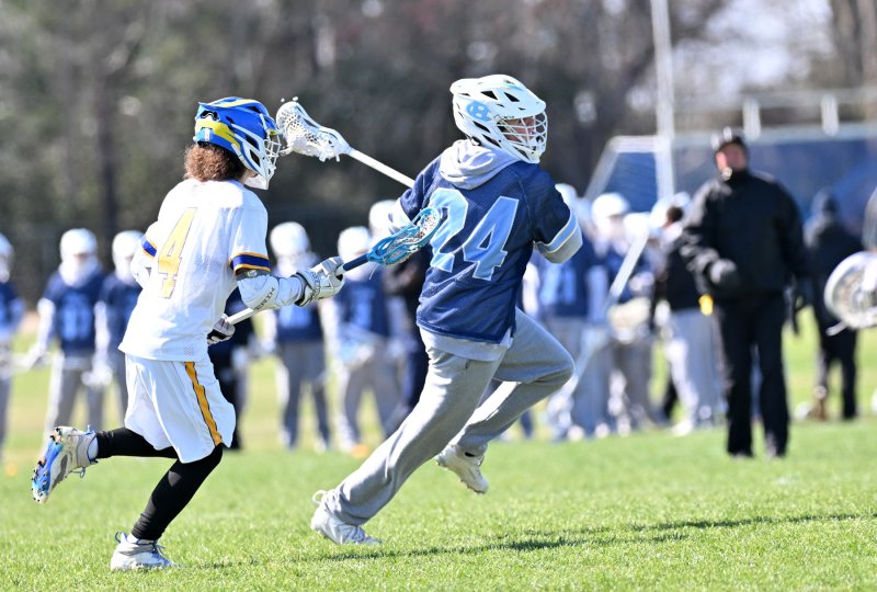 Cape junior middie Liam Crotty speeds past Central’s Ryan Warren then shoots and scores.