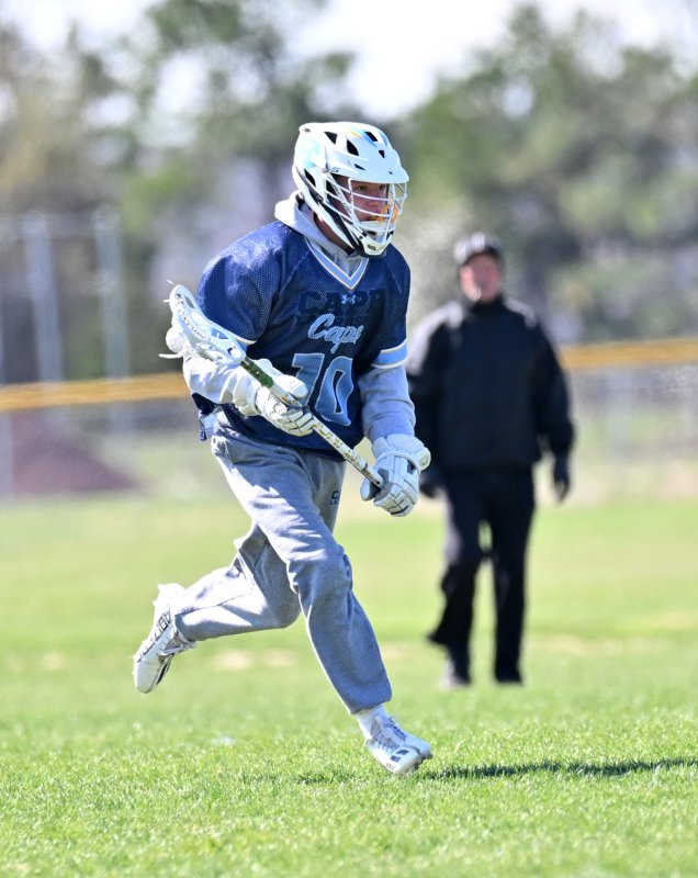 Sophomore Marshall Keys wins a face-off and goes to the Central goal.