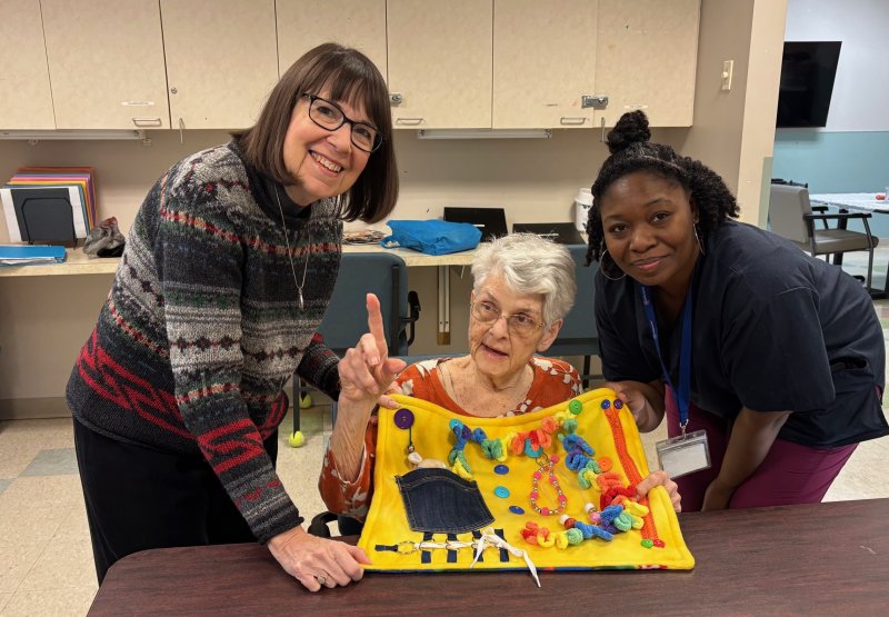 GFWC Delaware President Jan Conant, left, shares a fidget blanket with Jackie Keyer Taylor and Ebony Keaton of Easterseals. SUBMITTED PHOTOS