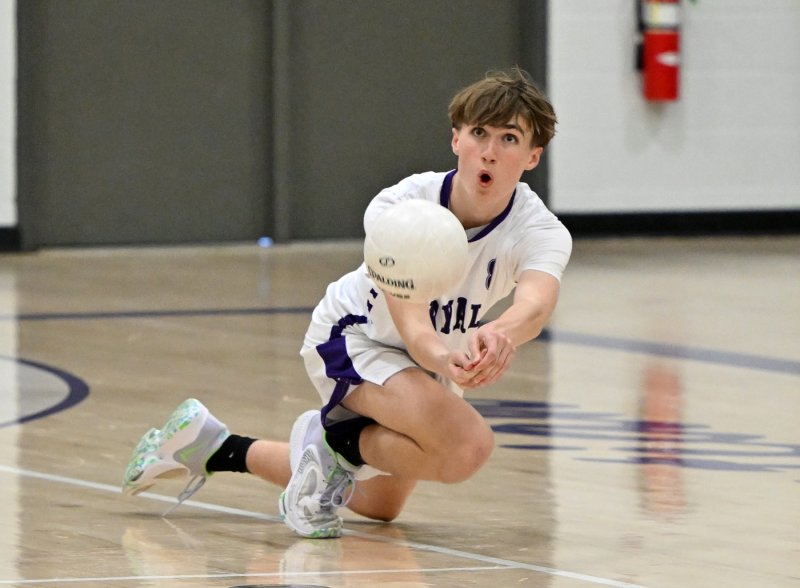 Royals sophomore Donavan McCartney bumps a save on the sideline.