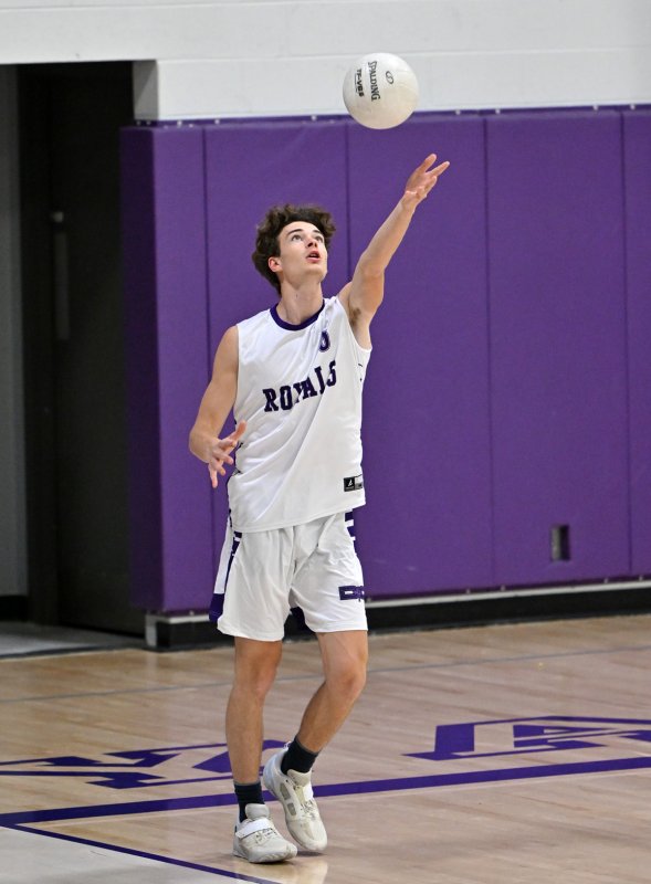 Royals senior James Baxter serves a winner.