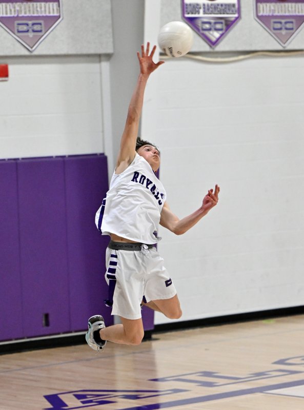 Royals sophomore Henry Ennis pounds a jump serve.