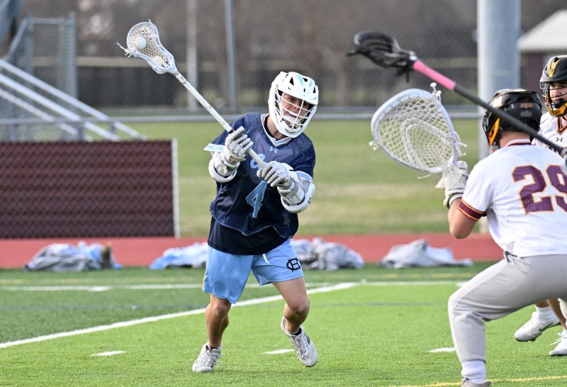 Cape’s AJ Grapski shoots on Milford keeper Landen Hill.
