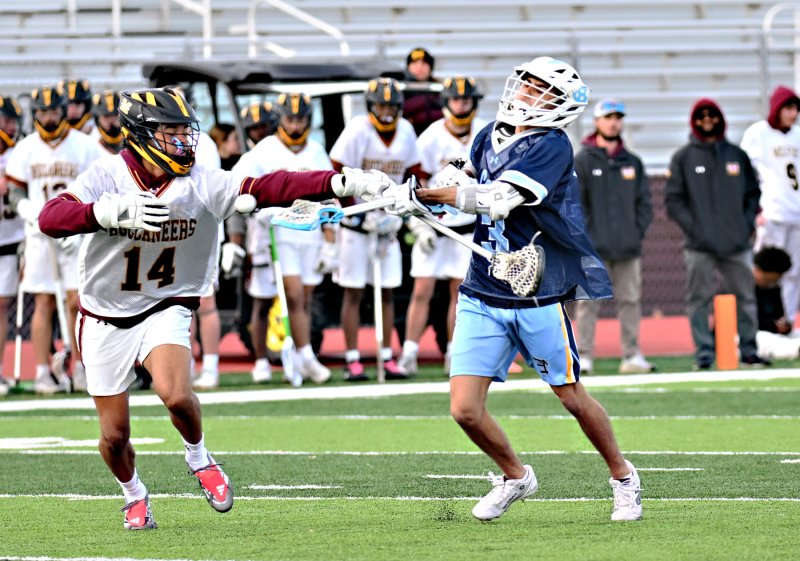 Cape’s Carter Nemcic cranks the rock despite the defense by Milford’s Aaron Walker. DAN COOK PHOTOS