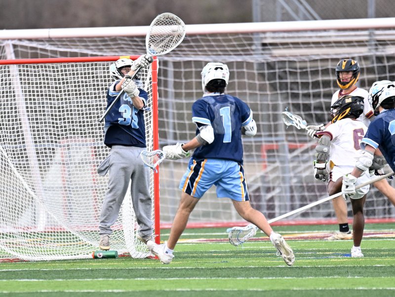 Cape senior goalie Mason Trench makes a save on Milford’s Andrew Sivels.