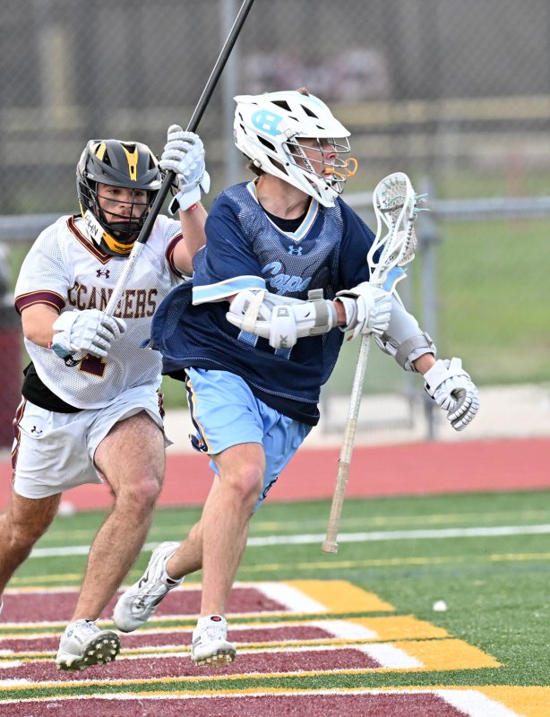 Cape senior Braddock Smith dodges around the Milford crease.