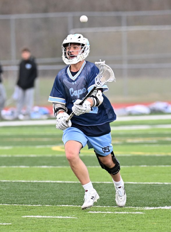 Cape senior Ryan Morgan passes to the Bucs’ crease.