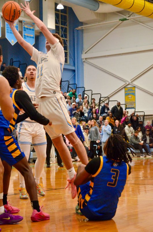 Cape senior Braxton Figgs finishes at the cup after fighting for an offensive rebound.