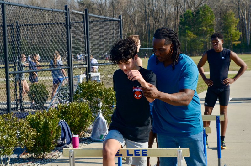 Seahawks coach Shawn Hopkins shows eighth-grader Damian Lucero-Sandoval where his limbs should be.