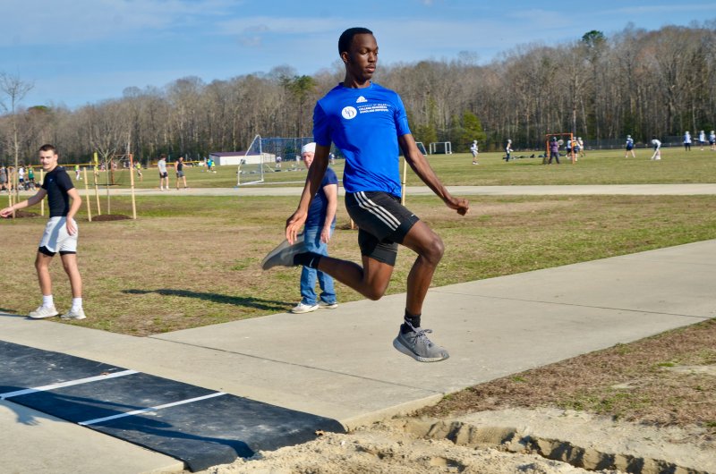 Sussex Academy senior Jesse Jean-Louis keeps his chest out and his arms down on a jump.