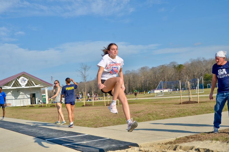 Seahawks sophomore Nadia Ahmed’s landing is watched by coach Charlie Pollard.