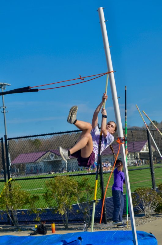 Seahawks freshman Claire Denham pole vaults up into the blue sky.