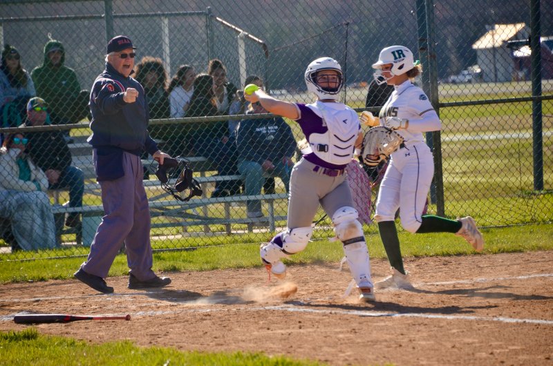 Delmarva Christian sophomore MaryKate Dougherty tries to turn two after stomping on home for the first out.