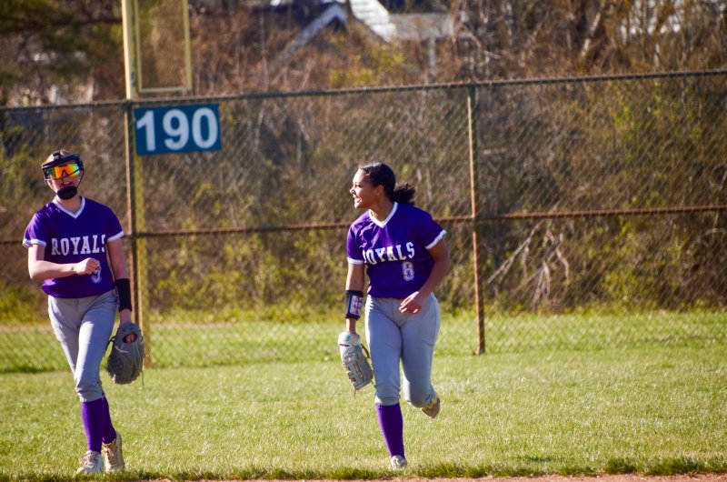Delmarva Christian freshman Grace Hicks, right, smiles and laughs with freshman Addison Price after the former recorded an out.