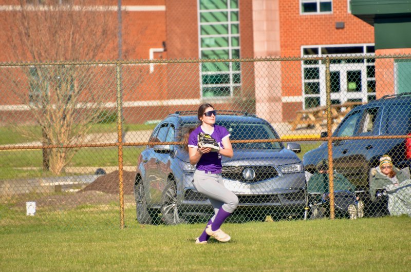 Royals senior Eve Bohinski begins to throw the ball in after recording an out.