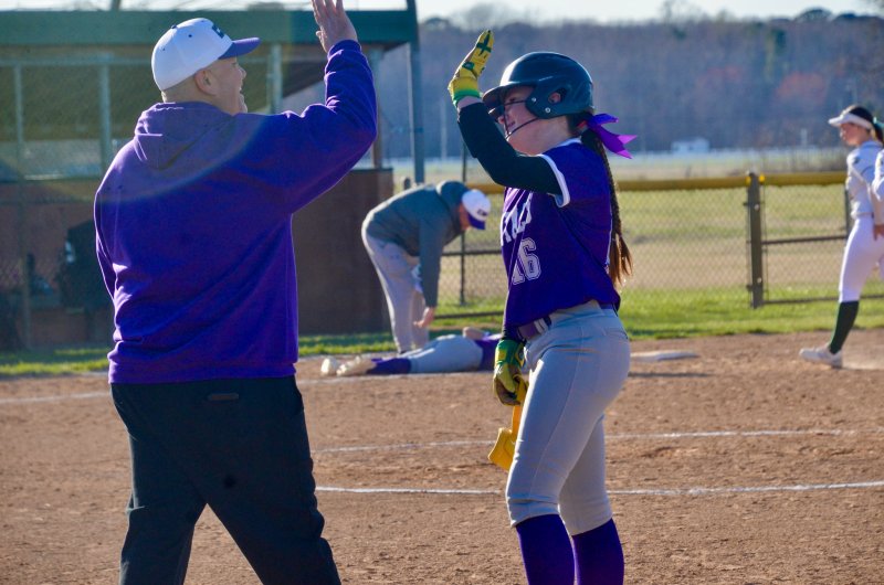 Royals eighth-grader Carsyn Riddle is congratulated for her RBI single.