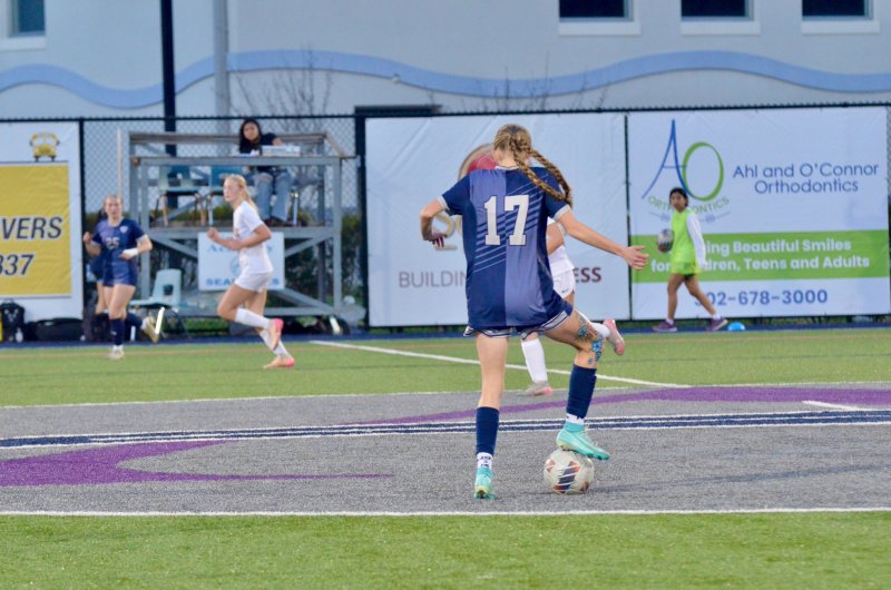 Sussex Academy freshman Leah Cooper controls the ball at the logo.