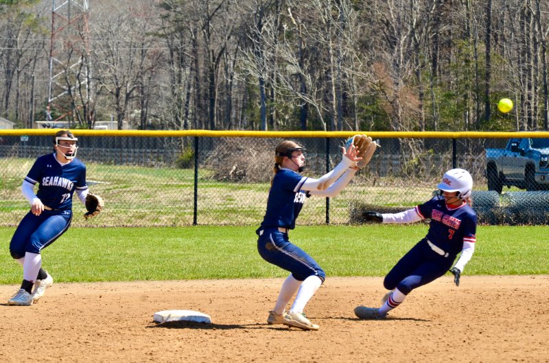 Seahawks freshman Danica Bergh watches the dart from Delainie Monitzer into her glove before tagging the baserunner out on the helmet.