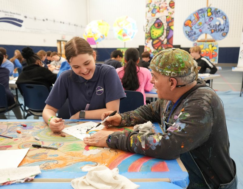Sussex Academy eighth-grader Curlett Walsh, left, gets input on her artwork from local artist John Donato during a creative art experience led by Donato at the school March 13.