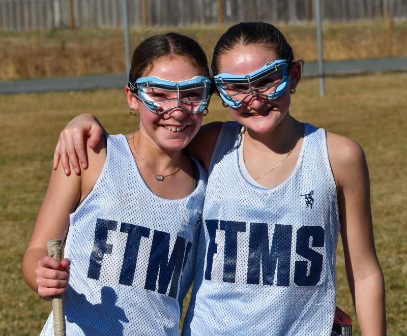 Millie Alleman and Finley Conn take a break from lacrosse practice at Fred Thomas. DAVE FREDERICK PHOTOS