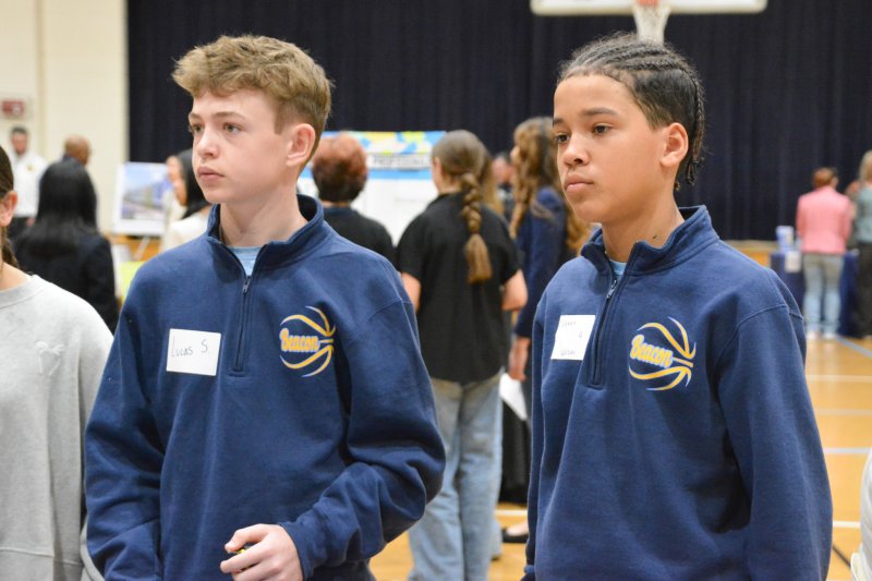 Beacon Middle School students Lucas Skonieczki, left, and Colton Wilson listen closely to career fair guest Nancy Lee Rodden of ILC Dover Astrospace. SUBMITTED PHOTOS