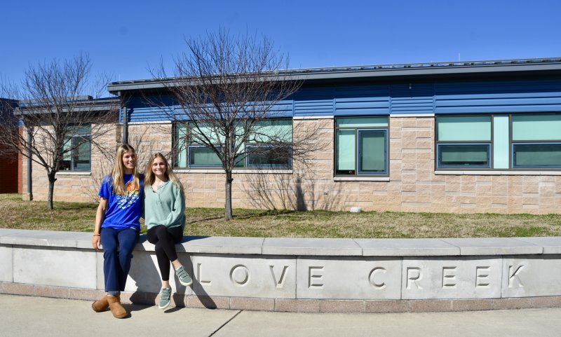 Future psychologists (l-r) Amalia Fruchtman and Mallory Terhune pose outside Love Creek Elementary.