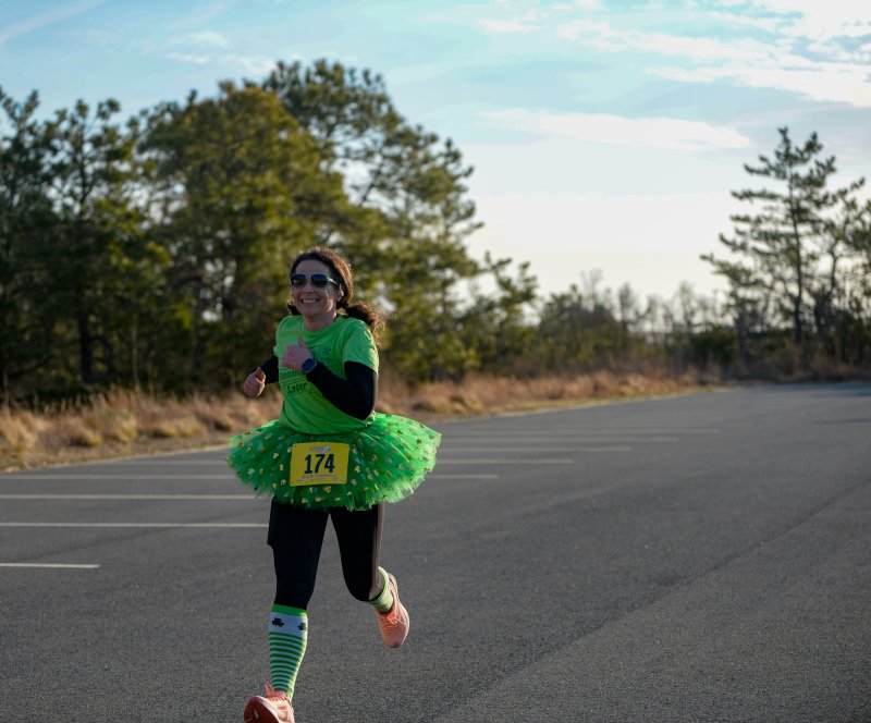 Angela Messick crosses the 5K finish line in 23:58.