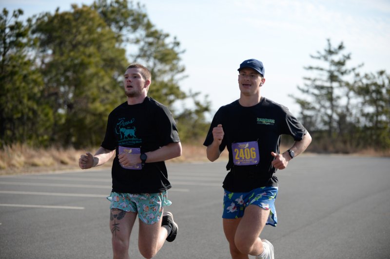 Bennett Brumbley and Blake Stillman cross the half-marathon finish in 1:34:55.