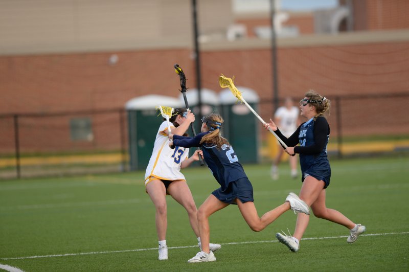 Layla Conn and Kemper Cox play defense against Madalyn Beron.