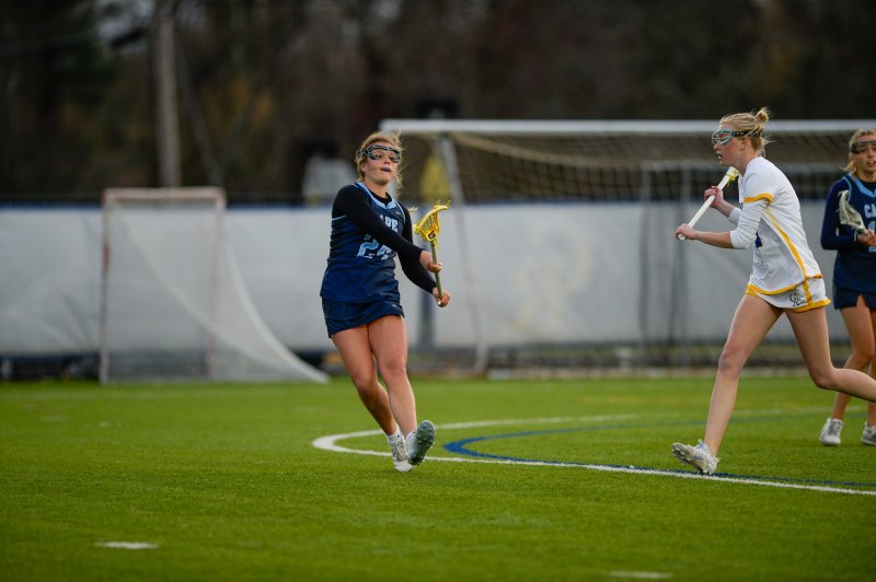 Kemper Cox, a sophomore attacker, is guarded by Delaney Miklus.
