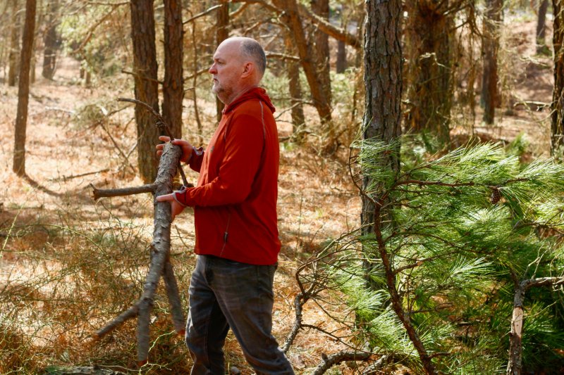 John Lester helps clear the hole.