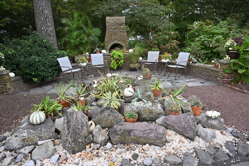 A beautiful fireplace highlights a sitting area in Fred and Alyssa Pepper’s garden. DAN COOK PHOTO